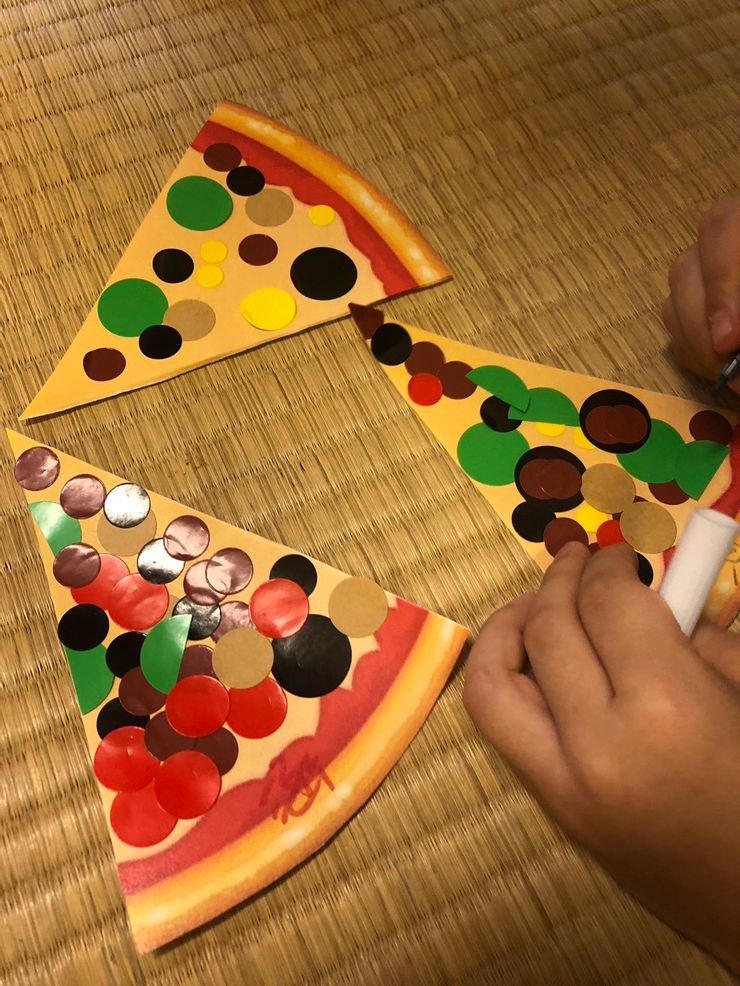 給孩子們各種顏色的圓點貼紙，讓孩子們聯想是披薩上頭的什麼口味。
